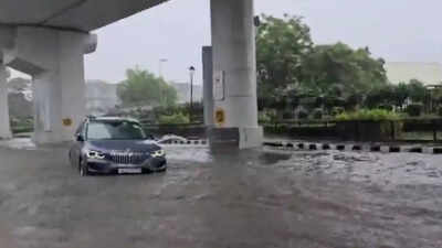 Delhi rains bring chaos: BMW sedan gets stranded on waterlogged road; traffic snarls across NCR – watch | Delhi News