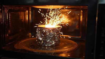 Why does aluminium foil spark in a microwave but not in an oven |